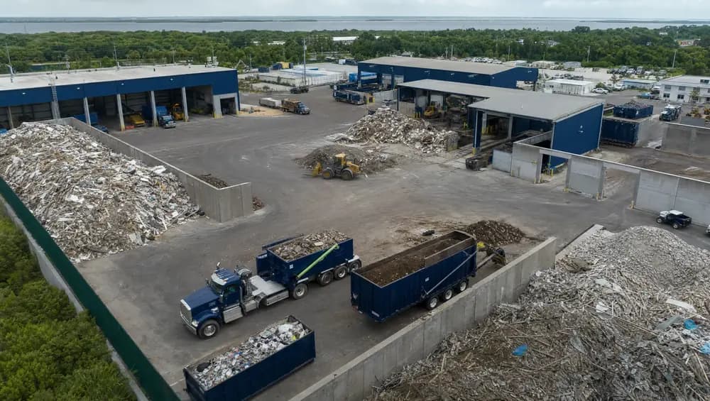 Construction debris disposal at a Clearwater FL transfer station with concrete and lumber piles